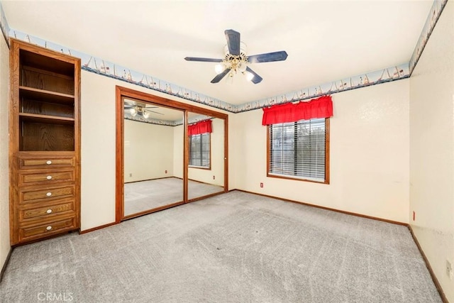 unfurnished bedroom with a closet, ceiling fan, and light carpet