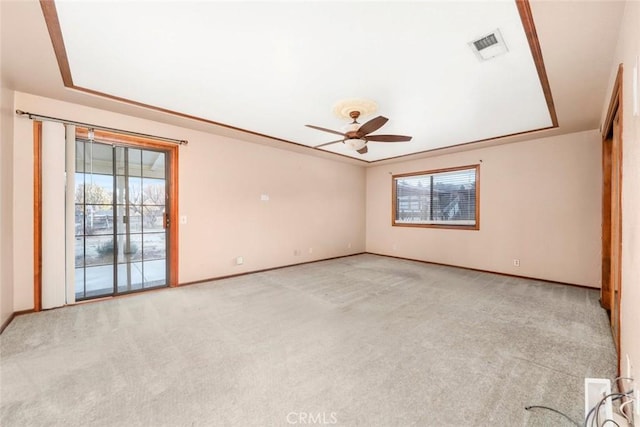 carpeted spare room featuring ceiling fan