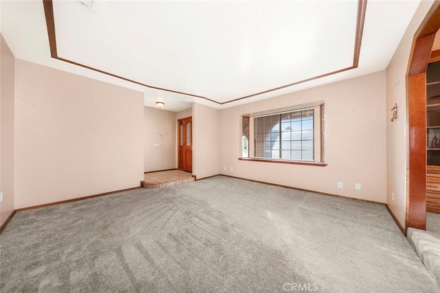 unfurnished room featuring light carpet