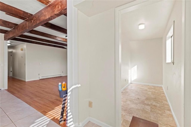 corridor with light tile patterned floors, beam ceiling, and baseboard heating