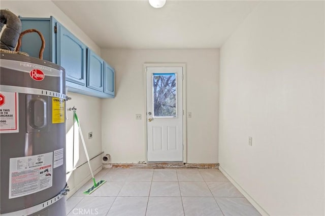 washroom featuring cabinets, light tile patterned floors, water heater, and hookup for an electric dryer