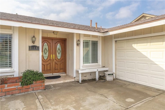 view of exterior entry with a garage