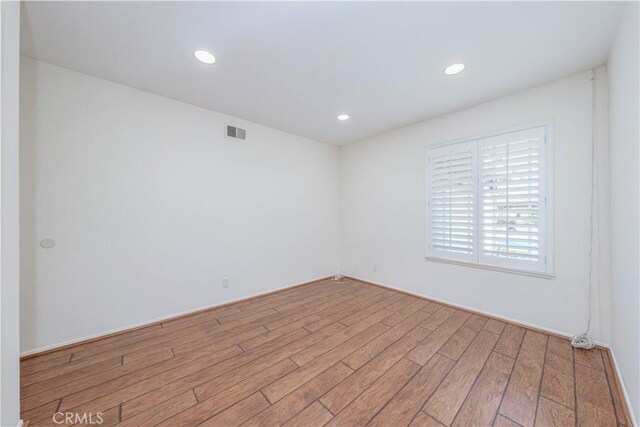 unfurnished room with light wood-type flooring