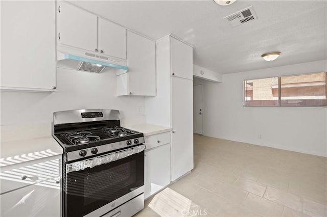 kitchen featuring gas range and white cabinets