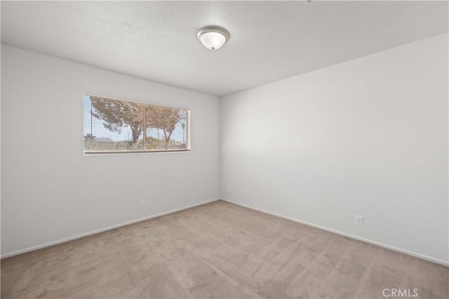 unfurnished room with light colored carpet