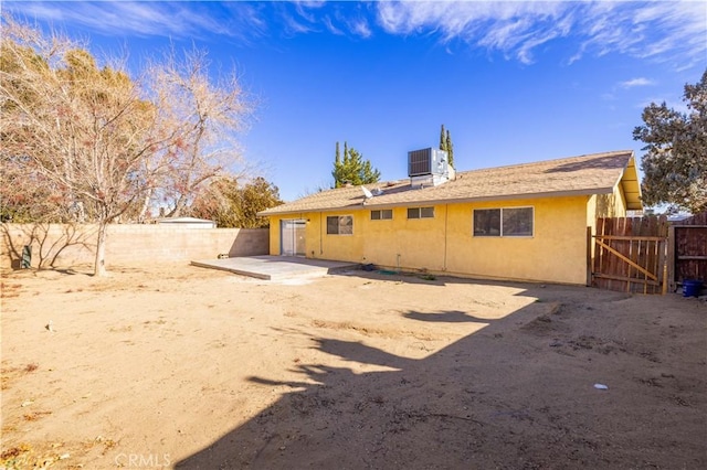 back of property featuring a patio and central AC