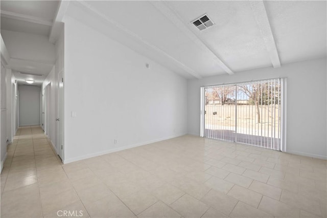 spare room with light tile patterned floors and beam ceiling