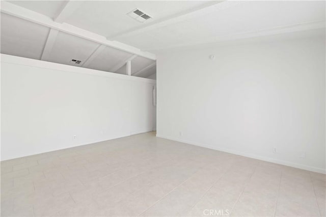 tiled empty room with lofted ceiling with beams