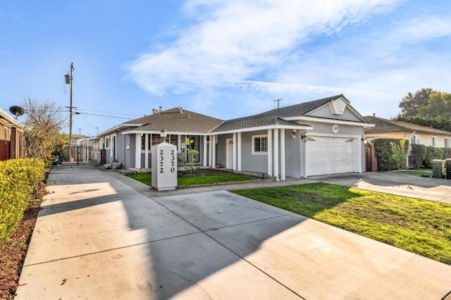 view of front of property with a garage and a front lawn