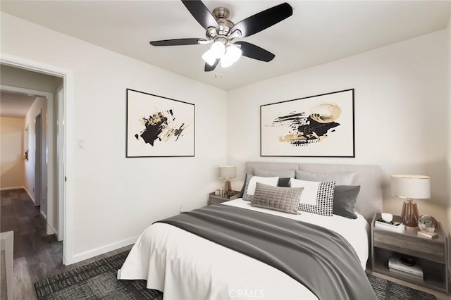 bedroom featuring ceiling fan and dark hardwood / wood-style floors