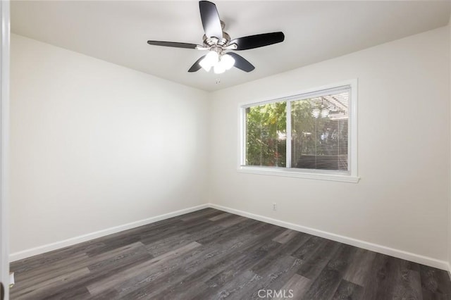 empty room with ceiling fan and dark hardwood / wood-style flooring