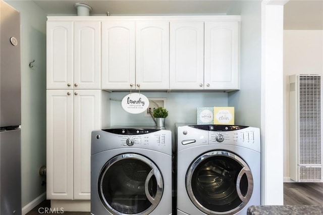 washroom featuring cabinets and independent washer and dryer