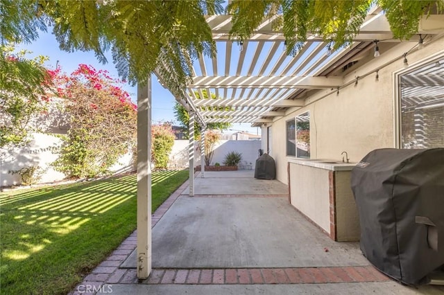 view of patio / terrace featuring area for grilling and a pergola