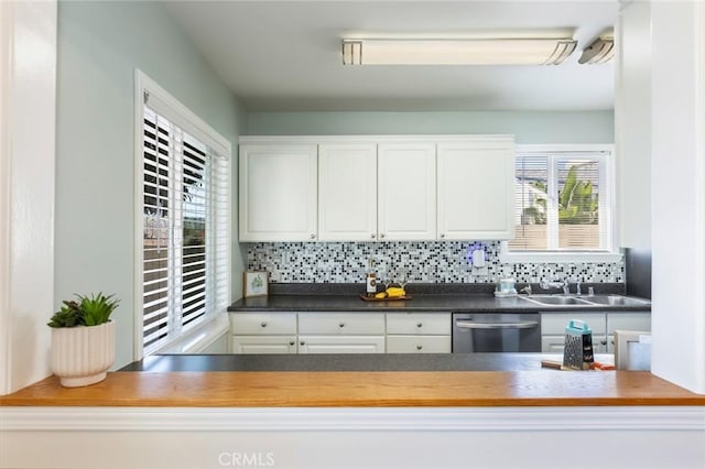 kitchen with sink, white cabinetry, dishwasher, and tasteful backsplash