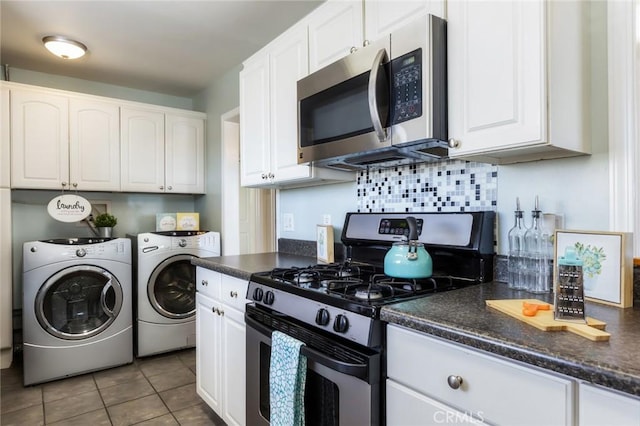 kitchen with white cabinetry, washer and clothes dryer, light tile patterned floors, and appliances with stainless steel finishes