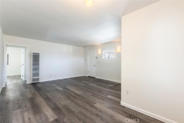 empty room with dark wood-type flooring