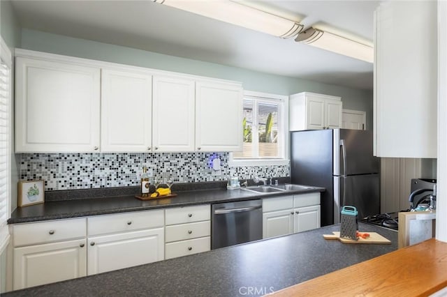 kitchen with sink, white cabinetry, appliances with stainless steel finishes, and decorative backsplash