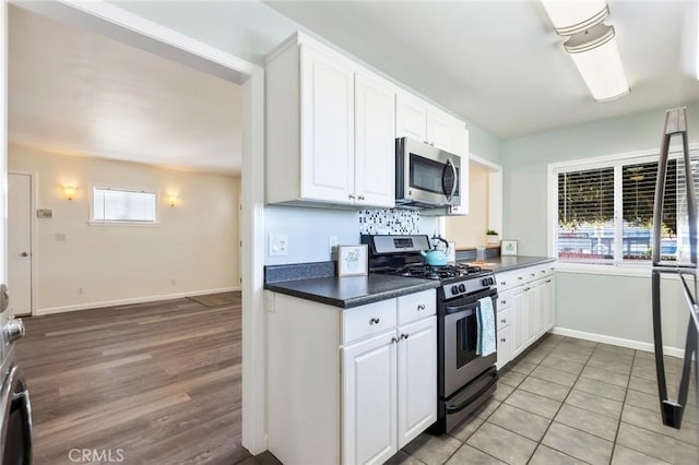 kitchen featuring white cabinetry, light tile patterned floors, and appliances with stainless steel finishes