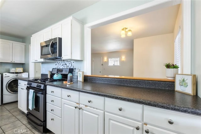 kitchen featuring washer / clothes dryer, light tile patterned floors, decorative backsplash, white cabinets, and stainless steel appliances