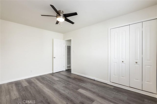 unfurnished bedroom with a closet, ceiling fan, and dark hardwood / wood-style floors