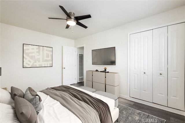 bedroom featuring a closet, ceiling fan, and dark hardwood / wood-style flooring