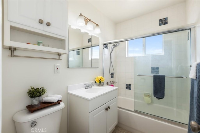 full bathroom with vanity, shower / bath combination with glass door, and toilet