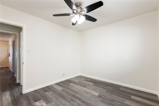 empty room featuring ceiling fan and dark wood-type flooring