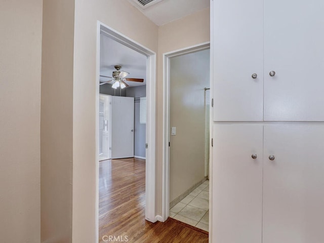 hall with hardwood / wood-style floors