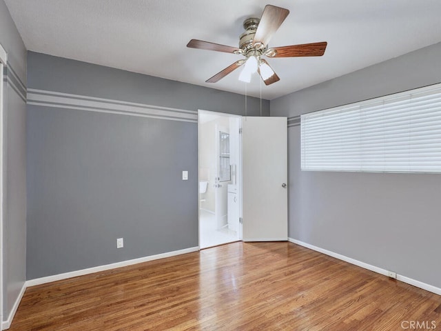 unfurnished bedroom featuring light wood-type flooring and ceiling fan