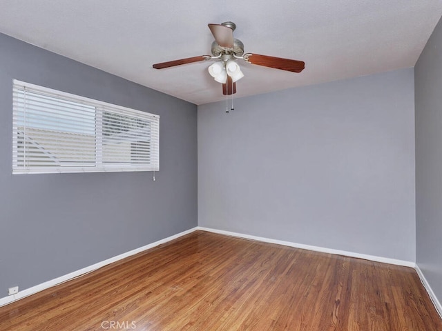 spare room featuring hardwood / wood-style flooring and ceiling fan