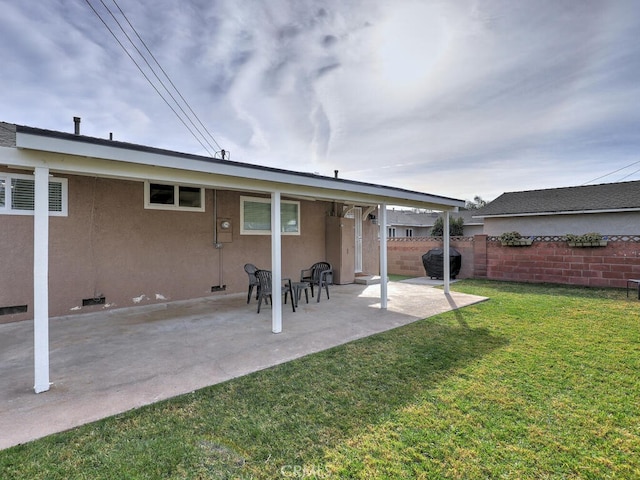 rear view of property with a patio area and a yard