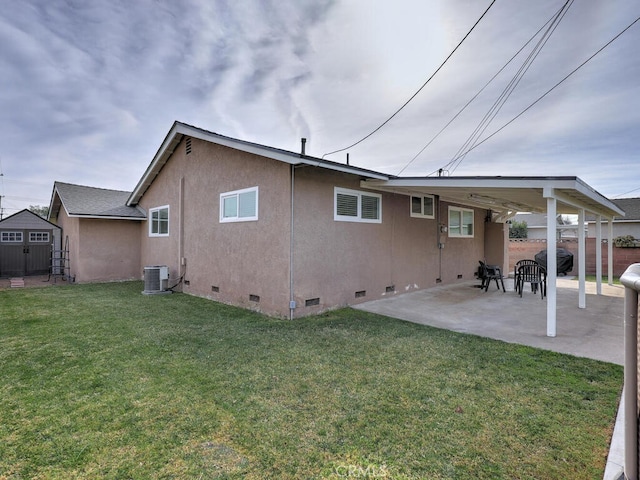 back of property featuring central AC, a lawn, and a patio