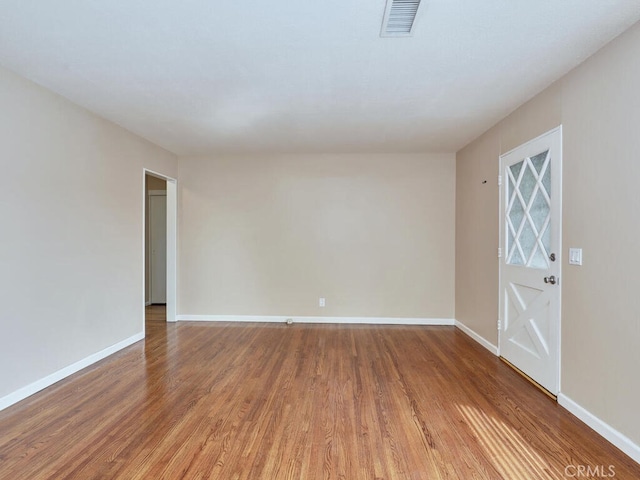 spare room with hardwood / wood-style flooring