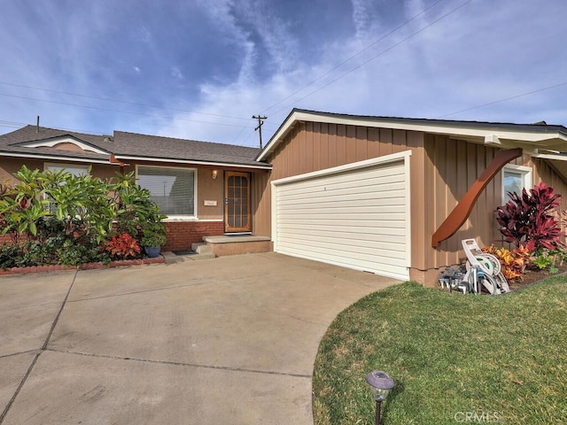 view of front facade with a garage and a front lawn