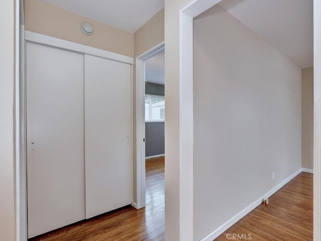 hall with hardwood / wood-style flooring