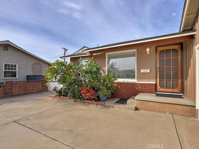 entrance to property featuring a patio