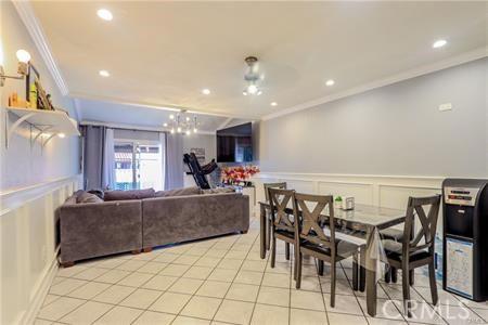 dining area featuring ornamental molding and light tile patterned flooring