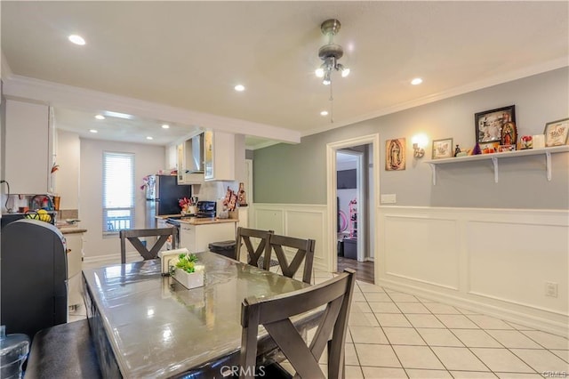 dining space featuring light tile patterned floors and ornamental molding