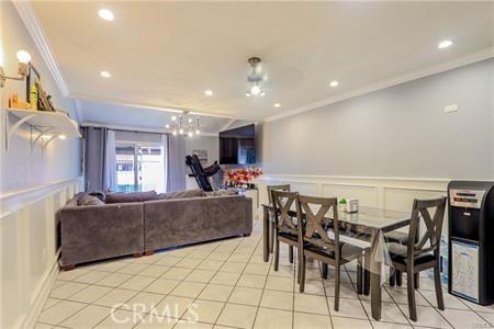 dining area with ornamental molding and light tile patterned floors