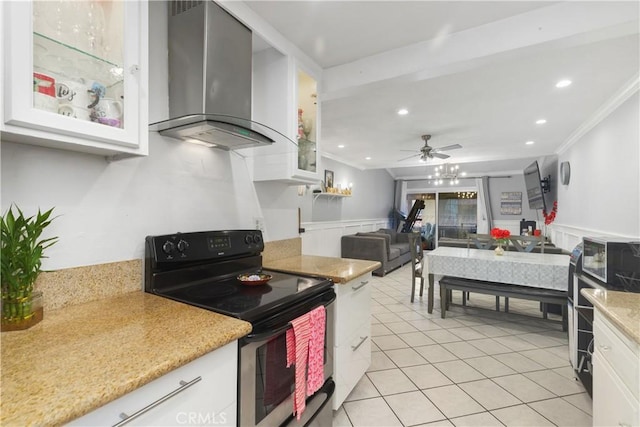 kitchen with ornamental molding, wall chimney exhaust hood, stainless steel electric range oven, and white cabinets