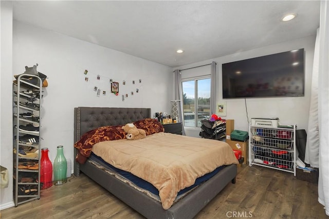 bedroom with dark wood-type flooring