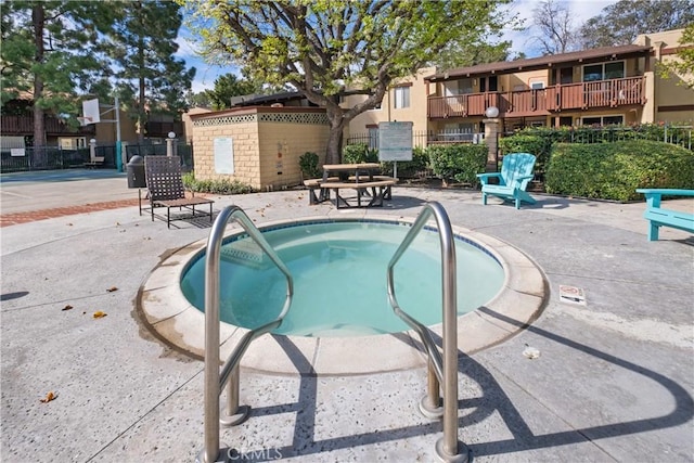 view of pool featuring a patio and a community hot tub