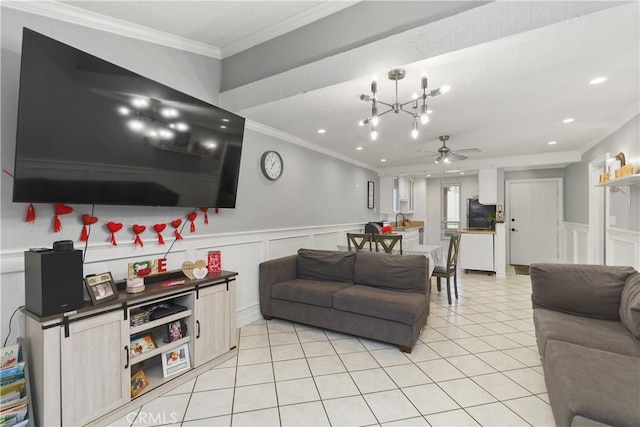 living room with ornamental molding, light tile patterned flooring, and ceiling fan with notable chandelier