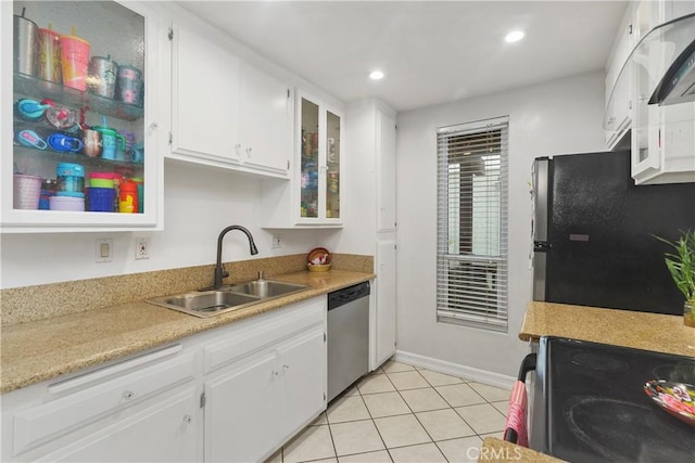 kitchen featuring sink, white cabinets, stainless steel appliances, and light tile patterned floors