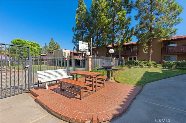 view of home's community featuring a lawn and a patio area