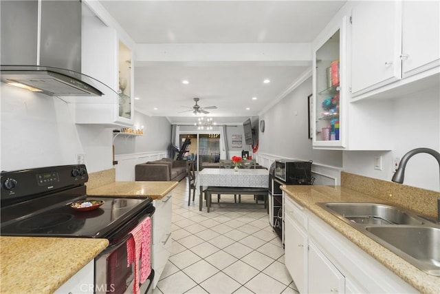 kitchen featuring black electric range, sink, white cabinetry, and range hood