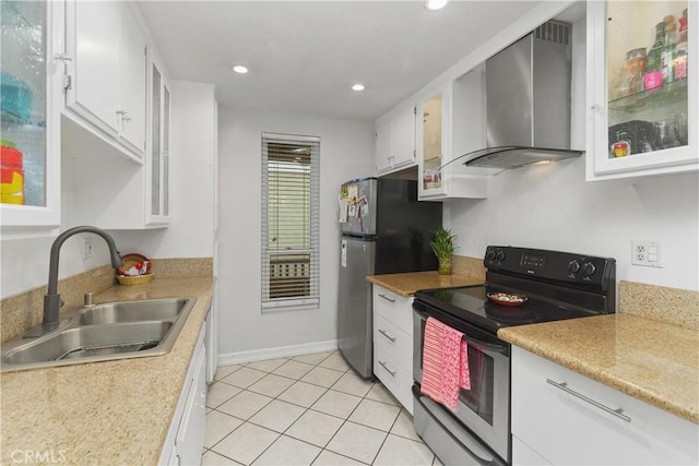 kitchen with sink, range with electric cooktop, wall chimney exhaust hood, white cabinets, and stainless steel refrigerator