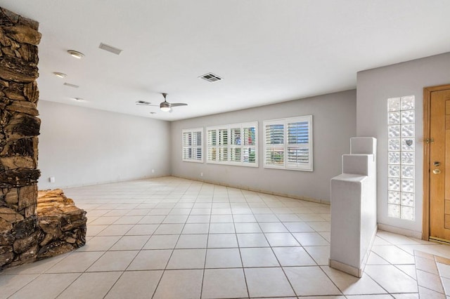 interior space with ceiling fan and light tile patterned floors