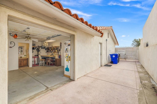 view of home's exterior featuring ceiling fan and a patio