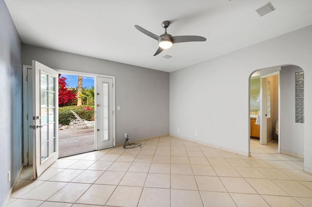 tiled spare room featuring ceiling fan